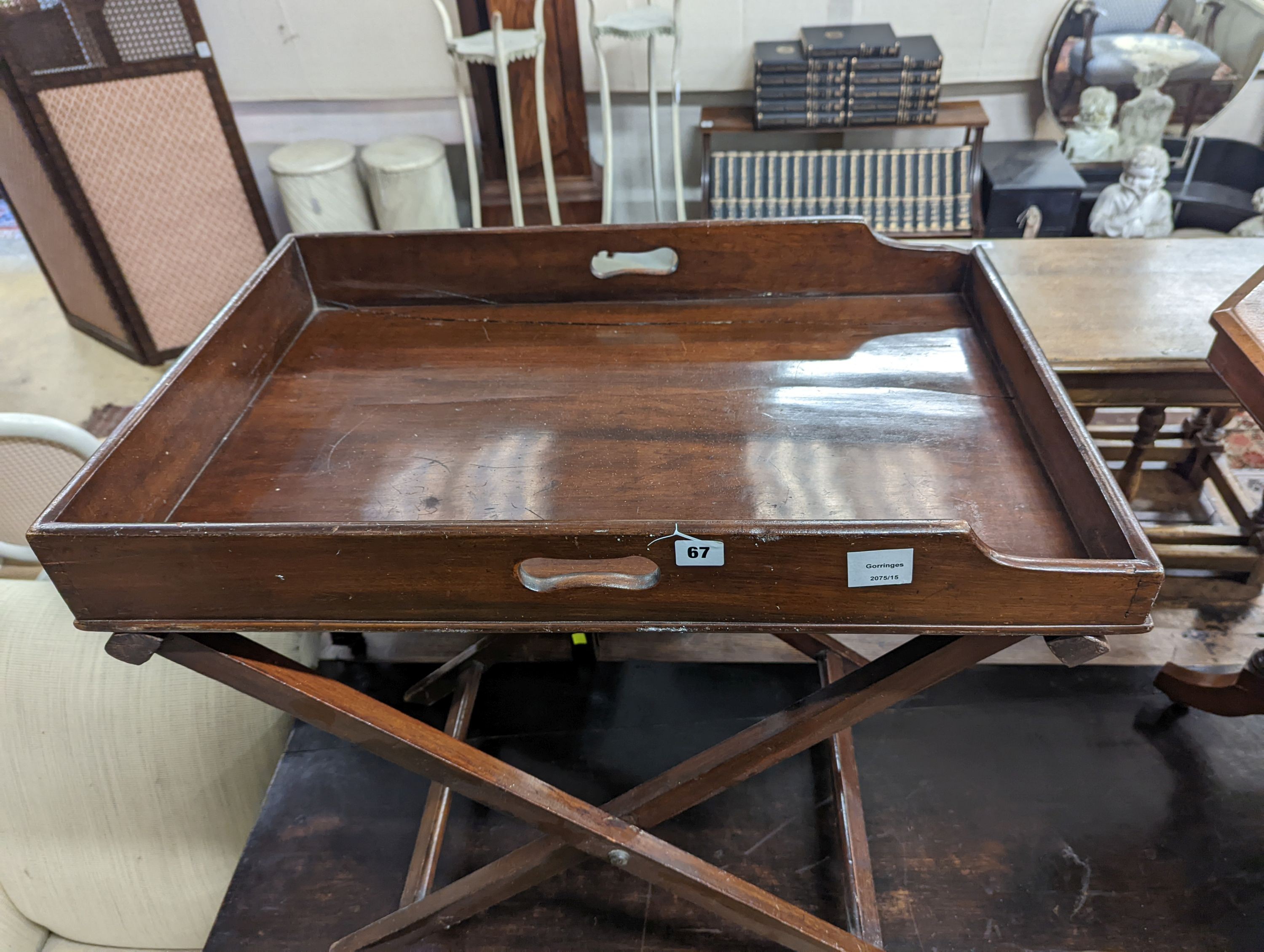A 19th century rectangular mahogany butler's tray on folding stand, width 24cm, depth 49cm, height 71cm